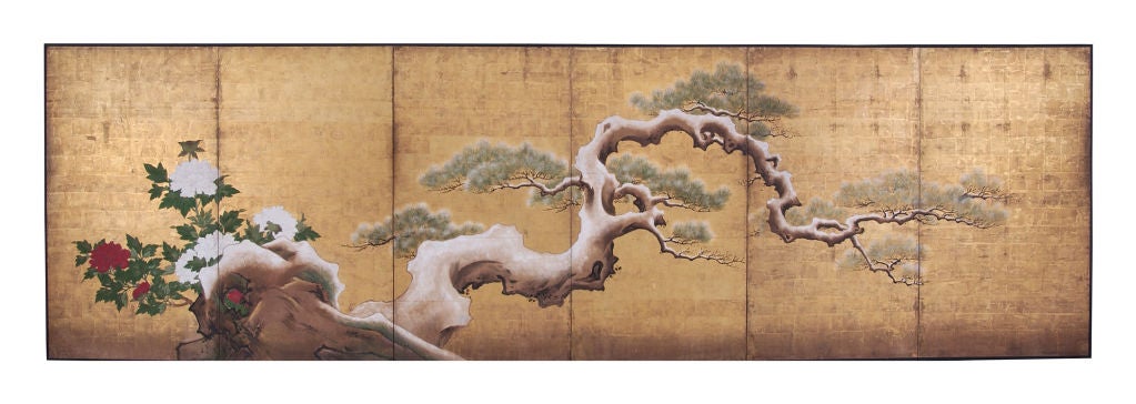An exceptionally large and finely painted Japanese six-panel folding screen (byobu) depicting an ancient, snow laden, gnarled pine tree on gold leaf ground. The tree grows from a rocky outcropping with a group of white and red peonies. The pine tree