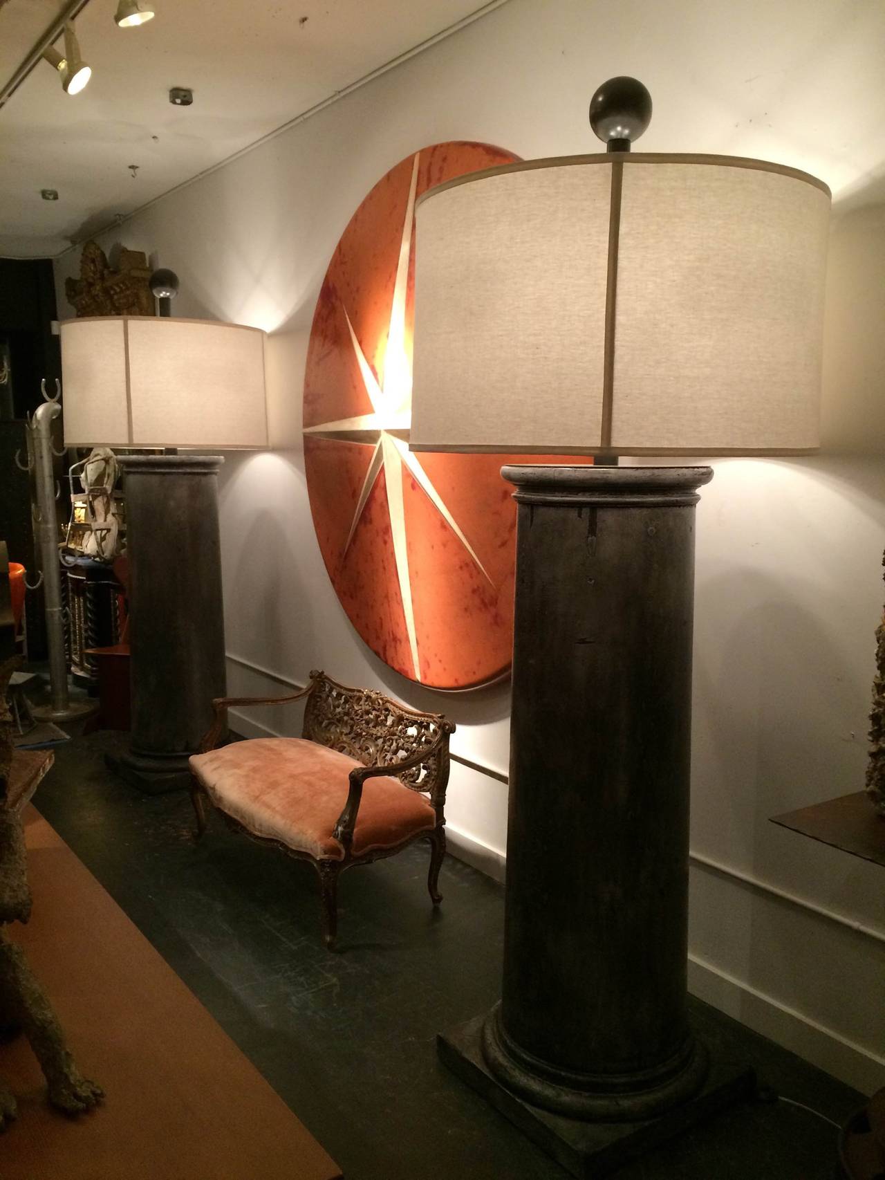 The bases of these huge 8.5 ft tall floor lamps are reclaimed wooden architectural fragments harvested from an estate here in Seattle and polished with several coats of European wax giving them an almost tarnished pewter look. The 39