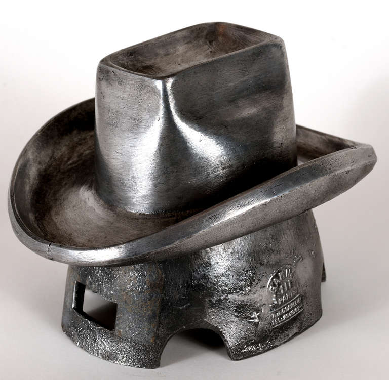 Cast iron hat mold with a French maker's mark, polished out to a high sheen.

Signed 'l. Garnot, Paris 37 Rue des Gravilliers'