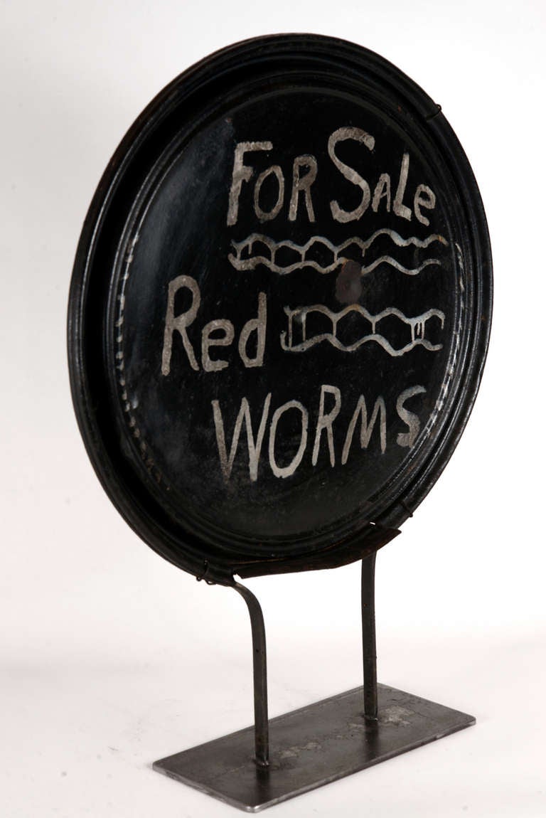 Another whimsical 'make-do' sign made from the lid from an old steel barrel, this one advertising the sale of red worms.  Most likely this was for temporary roadside selling, en route to a secret fishing hole.