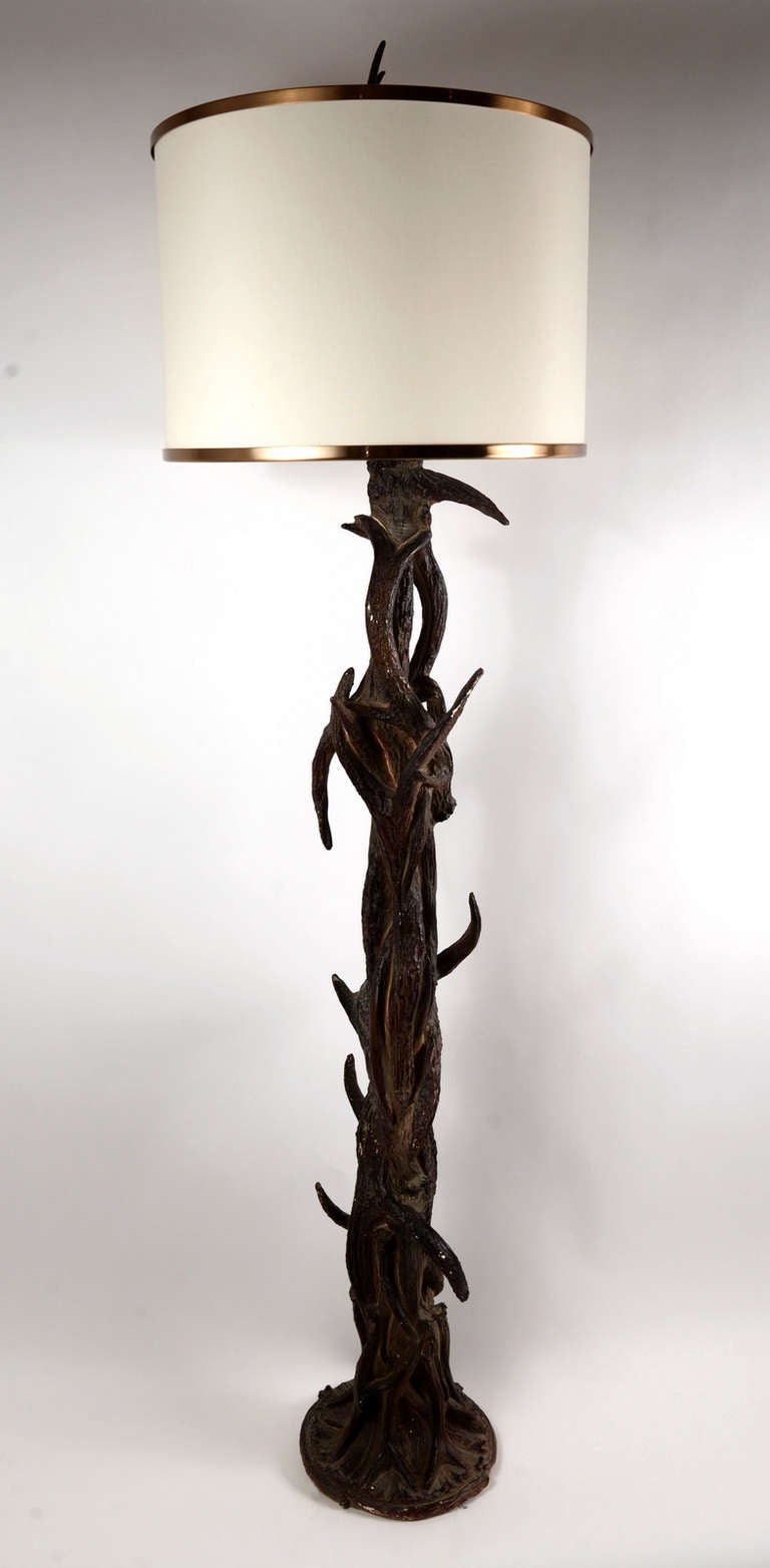Exceptionally well-made floor lamp from the 1960's with a lodge or hunting camp sensibility.  Cast and sculpted plaster with extraordinary texture and paint, rewired and with a chic new drum shade in the midcentury style.  It's gorgeous.