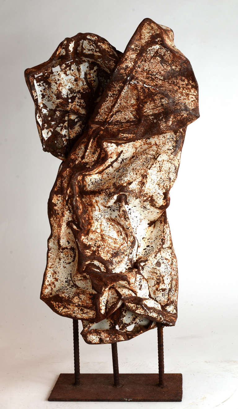 Vaguely male torso-like in shape, this found object steel sculpture is made from crinkled steel with rust coming through the old white paint.  Possibly an old fragment of an automobile fender.