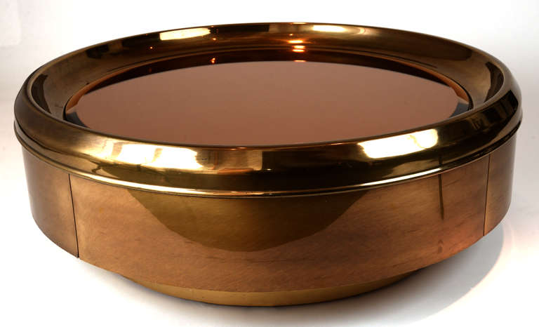 The sexy '70s are certainly reflected here (pardon the pun) in this gorgeous round brass low table with a beveled mirror in center.  The mirror itself is recessed three inches, inside a beveled ring.  The outside ring has a high polish for extra