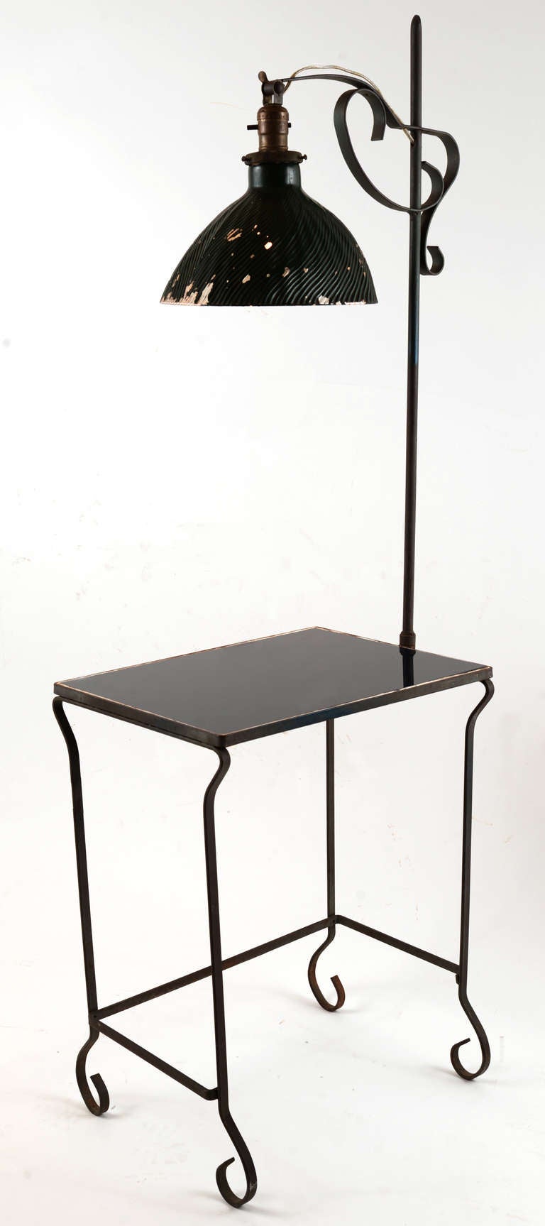 Simple, petite wrought iron and glass floor lamp side table combination in strap steel.  Lapis blue glass surface with a textured mercury glass reflector, our addition.
