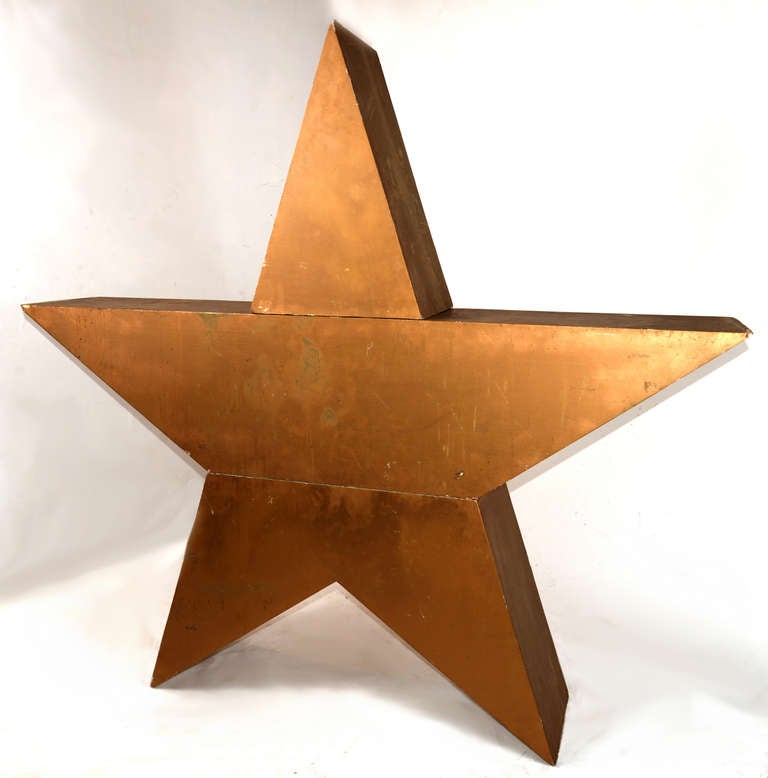 A gold-painted plywood five-point star in three sections, lightweight and easy to move.  Previously in a retail store as holiday decor. 

Who doesn't want a giant gold star?