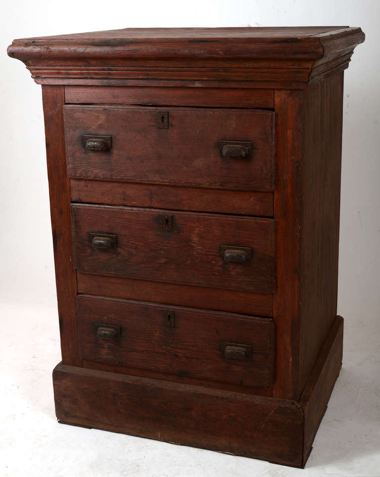 Big, bold, refined rustic gentleman's chest with three deep drawers, each having the original cast iron pulls and escutcheons.   Solid construction with rabbeted drawers, mitered corners at the upper & lower moldings, easy gliding drawer rails