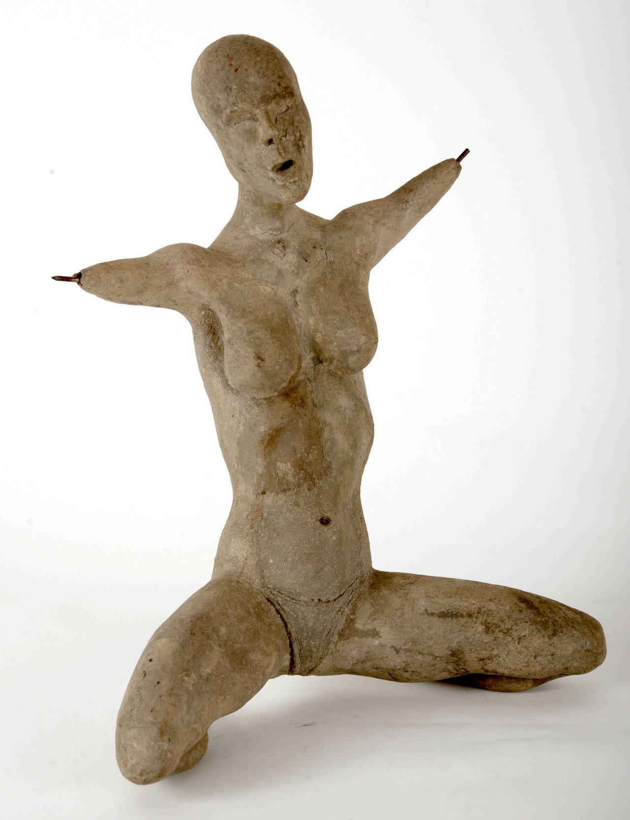 Unusual female form in an exaggerated kneeling position. Her hands and feet are represented by the protruding steel armature.