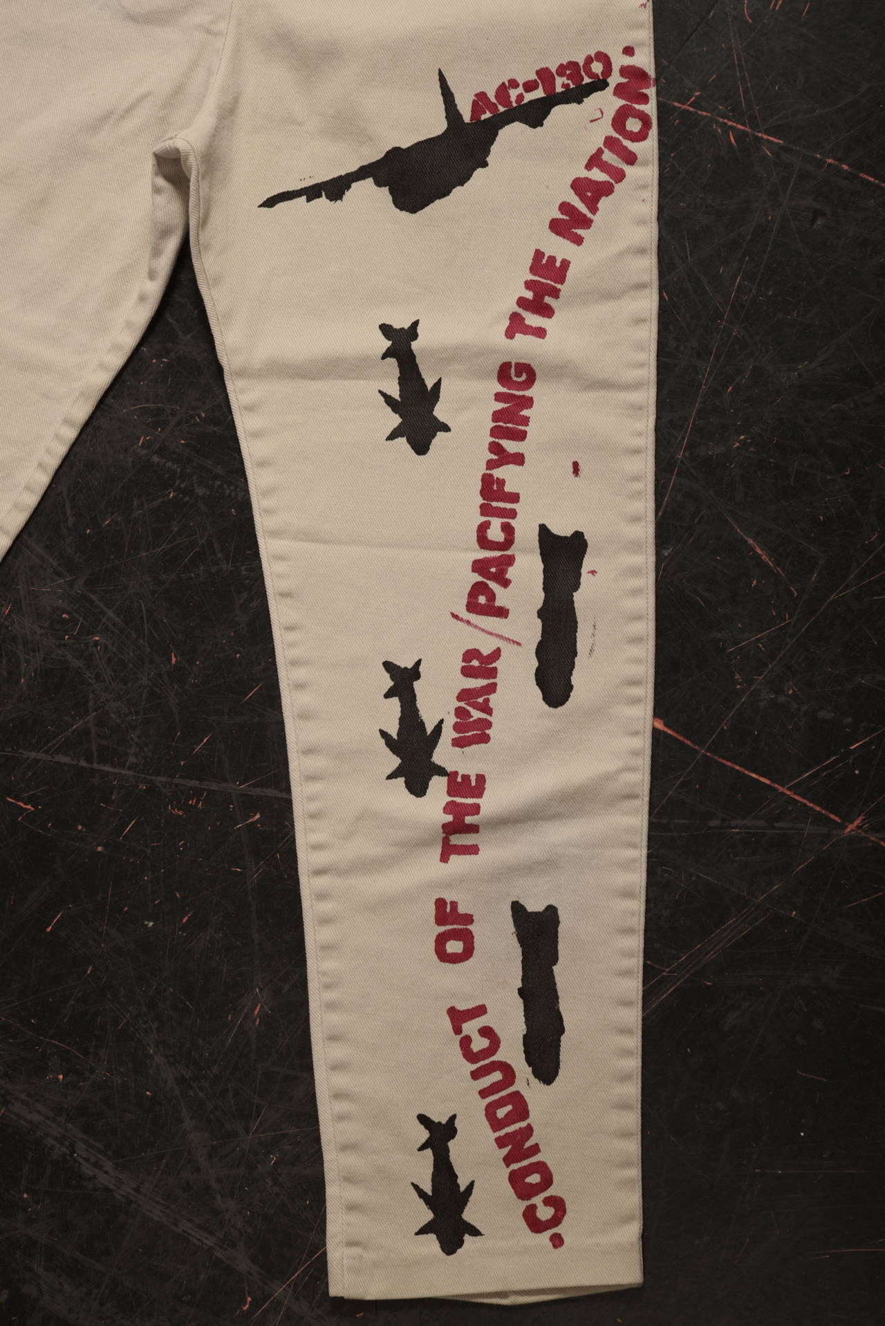 Hand-painted politically motivated pair of petal pusher pants featuring images of the Vietnam war. We know very little about the origin of this fascinating and unique garment only that it came from an estate here in Seattle.