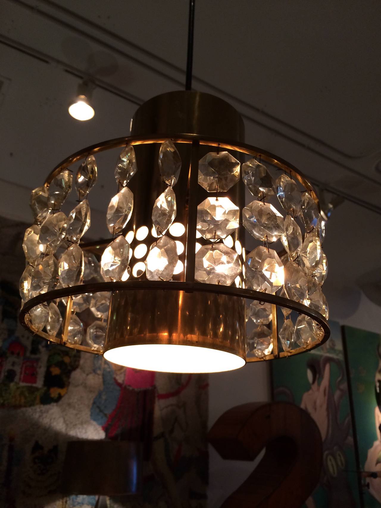 Bands of crystal bobbles surround a perforated brass housing on these super chic 1960s French pendants. These have been professionally restored and wired to US UL lighting standards. New custom brass canapés allow for easy installation.
