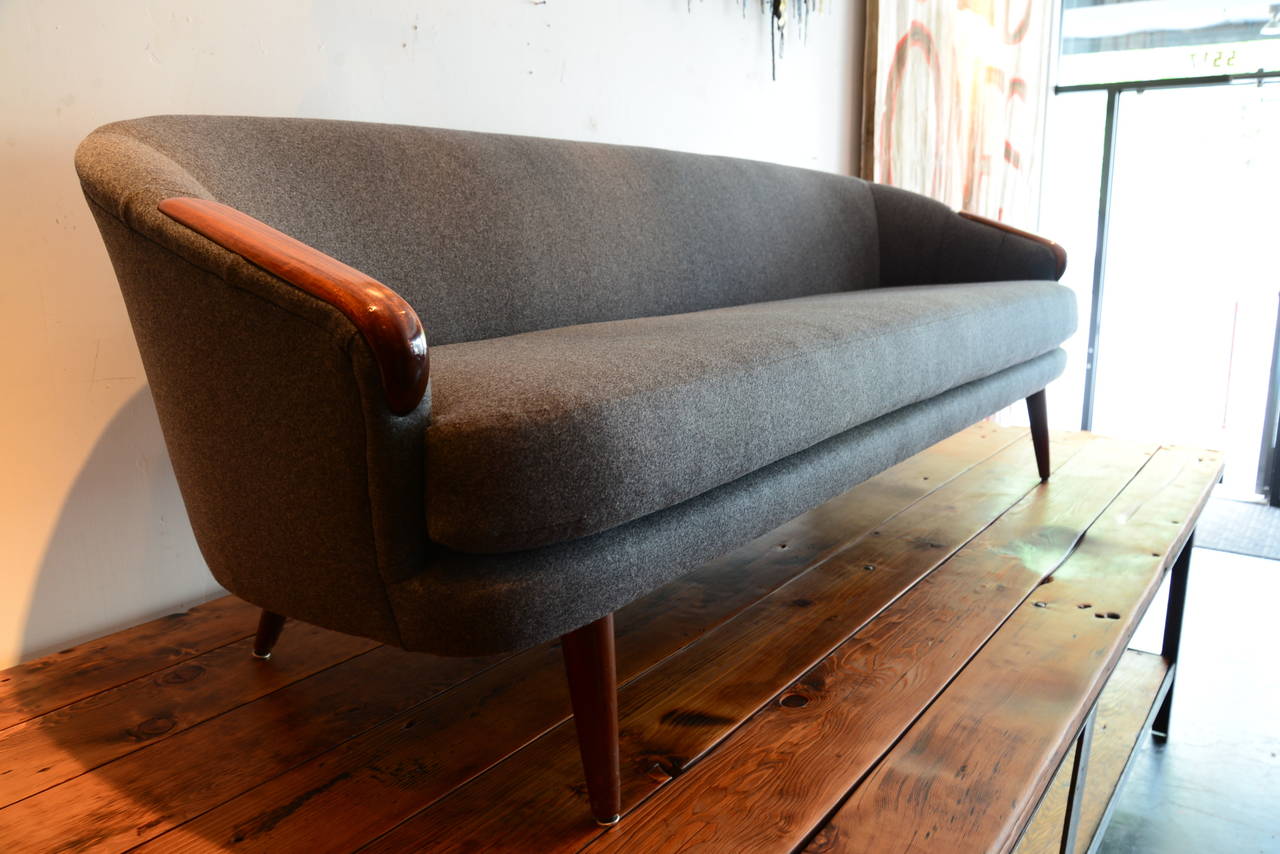 Very comfortable single cushion vintage sofa fully reconditioned and professionally upholstered in a stunning Rodoph wool. Rosewood arms and hairpin legs round out this Classic mid century gem.