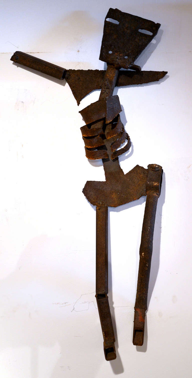 This unsigned welded steel found object creation is so wonderfully simple. The bend of the leg and outstretched arms instantly creates the image of a crucifixion.