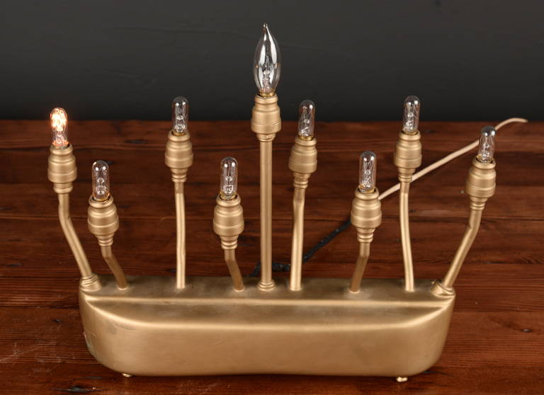 The individual switches on this gold painted menorah allow for individual lights to be illuminated.  What a fun find!