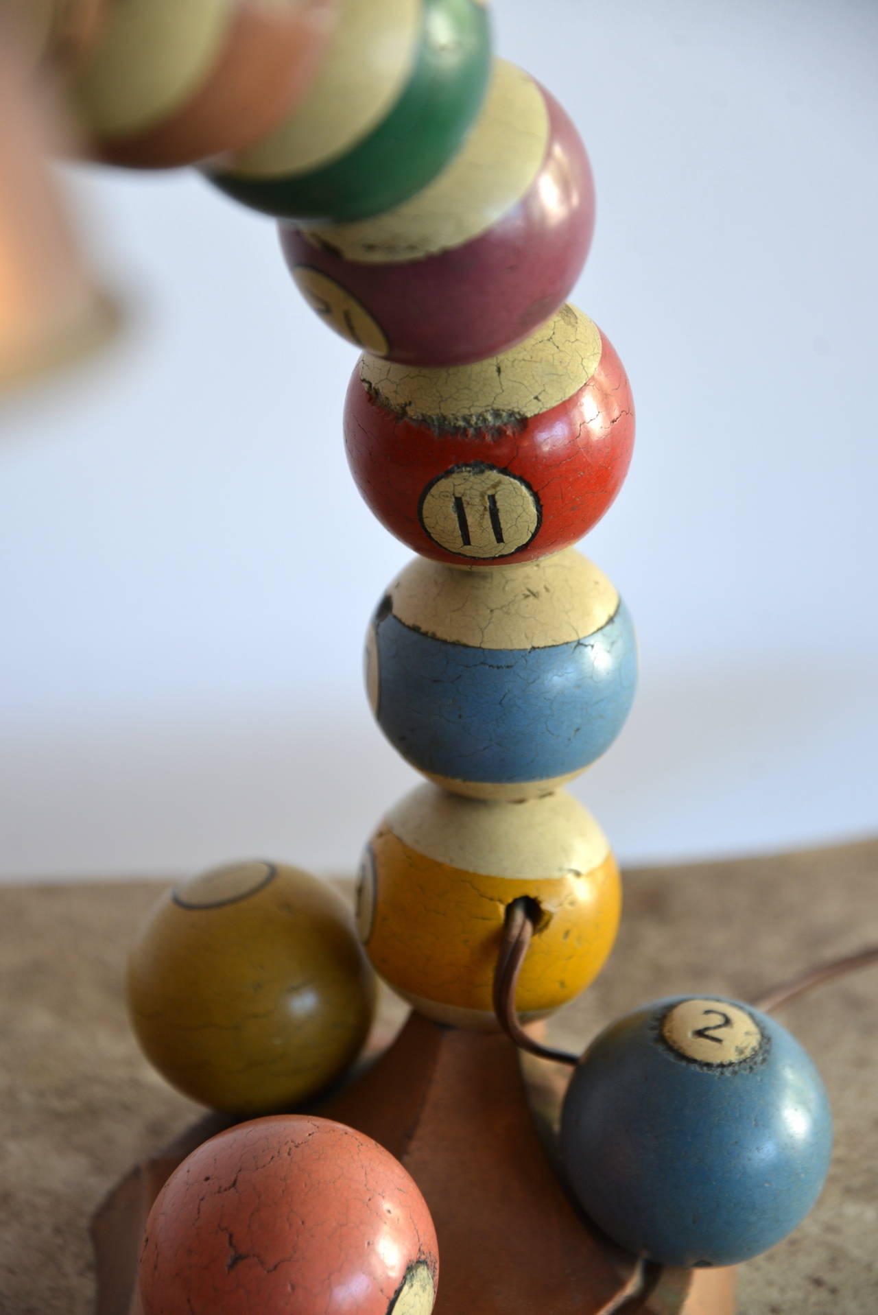 Vintage 1920s gooseneck adjustable table lamp adorned with vintage wooden pool balls.