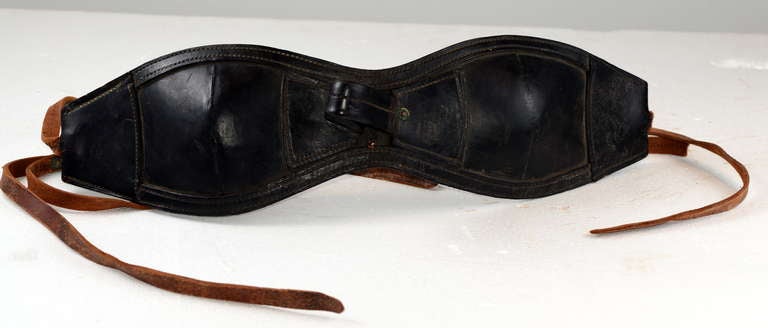 Old black leather horse or mule blinders, typically used to calm a high strung animal during transport via old truck or rail car.