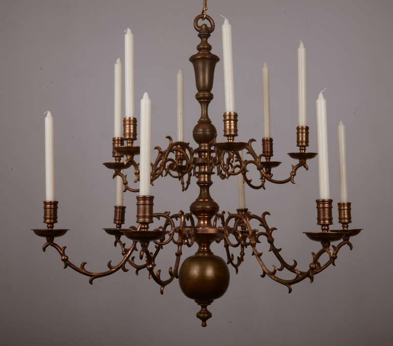 Beautiful French Baroque-style Chandelier with two tiers, six arms each.  The stylized leafy arms are beautifully cast with a gentle swag.

This is beautiful.