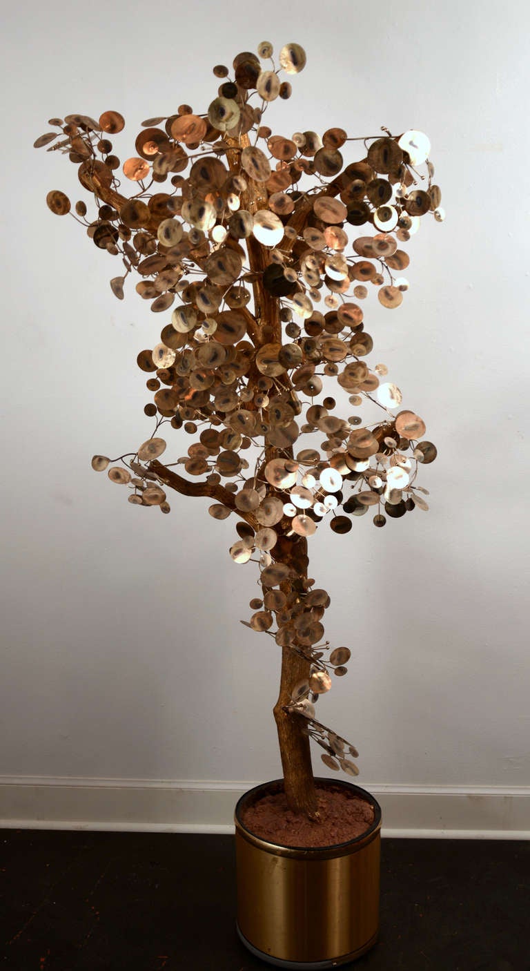 Mid-century sculptural tree with brass stylized leaves and a faux bark tree, planted in a brass pot.