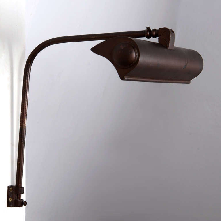 Signed I.P. Frink art lights in brass with mirrored interiors and elongated bulbs.