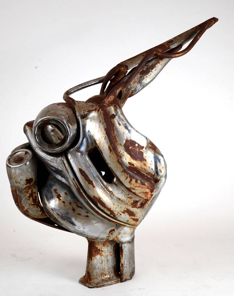 I picked this up on a recent trip to the San Francisco Bay area.  All the elements used in this unsigned original sculpture appear to have been salvaged from automobiles.....bumpers and headlight housings.  I was told, though I can't confirm, that