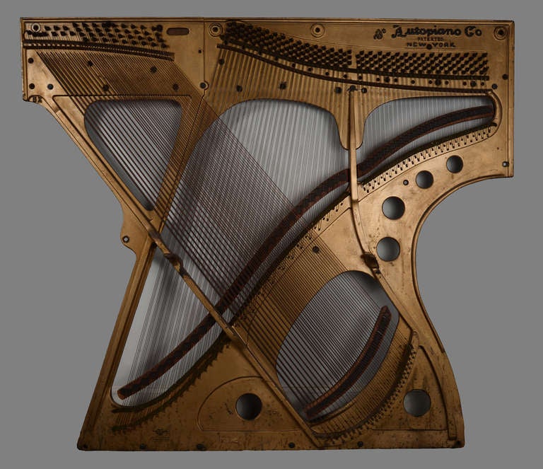 Sculptural, geometric, harp-like cast iron plate from an early 20th player piano,  rethought here as a wall-mounted piece of art.   Made by the popular New York maker with a company mark intact, Autopiano.  With original old gold paint and all
