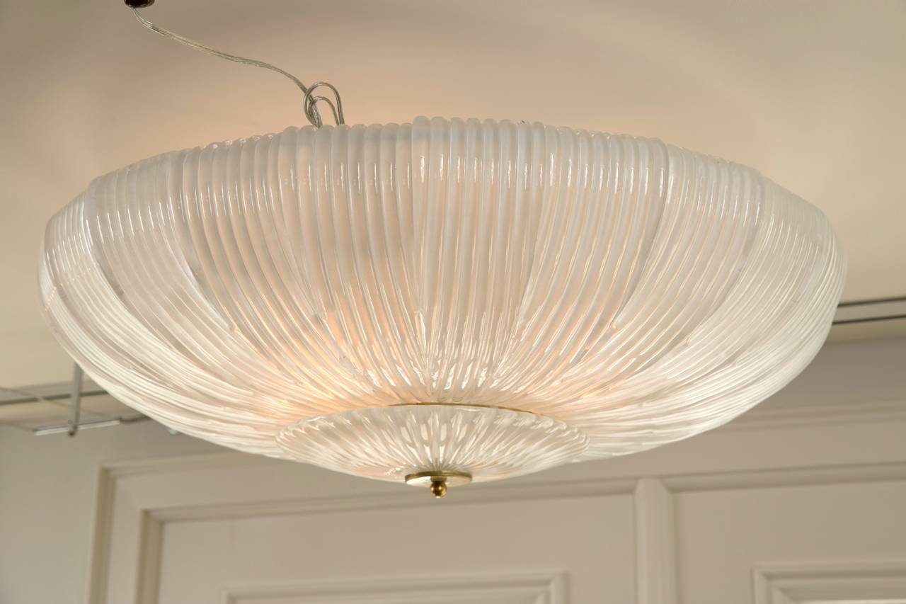 Wonderful Murano blown ceiling fixture comprised of 24 separate shimmery opaque and ribbed pieces creating a very unique and modern effect.
Can be displayed as a near flush mount or dropped to any height.
Venice, Italy.
Sold as install ready and