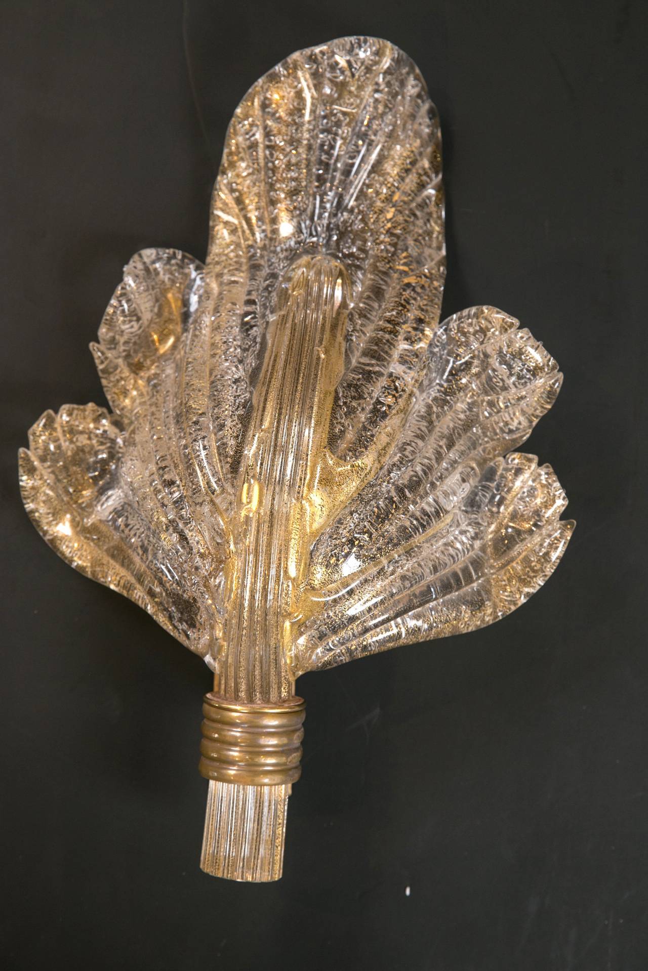 A spectacular set of vintage icy Murano gold blown leaves mounted as wall lights. No leaf identical and blown in free-form. Note undulating movement and expression- Attributed to Barovier from circa 1960s, Venice.
Note the illuminated leaf is lit