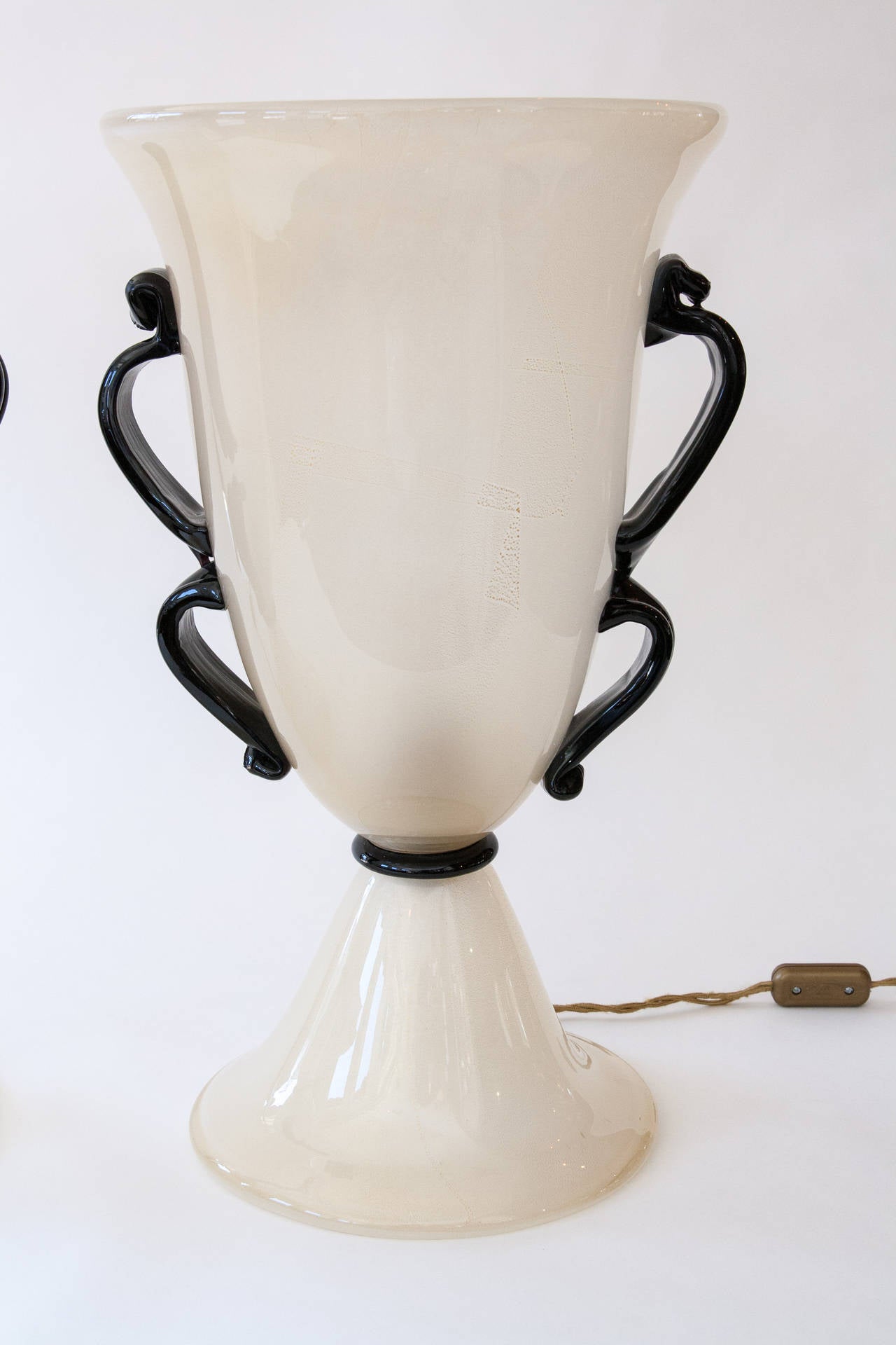 Exquisite pair of Murano blown gold on white uplight vases with black double handles, marked Barovier e Toso, circa 1960.