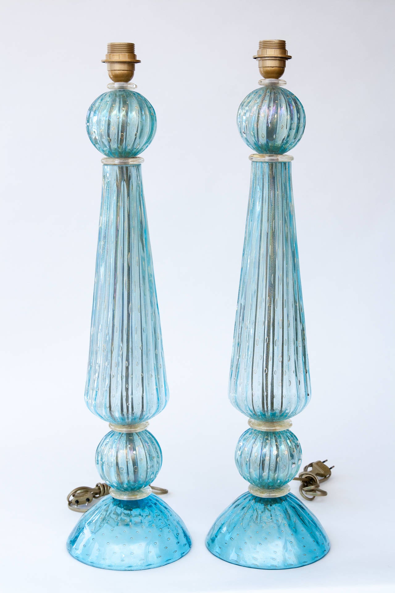 Each lamp is comprised of four separate aquamarine blown pieces with gold bubbles and with gold blown disks in between, stamped Seguso.
Spectacular color!