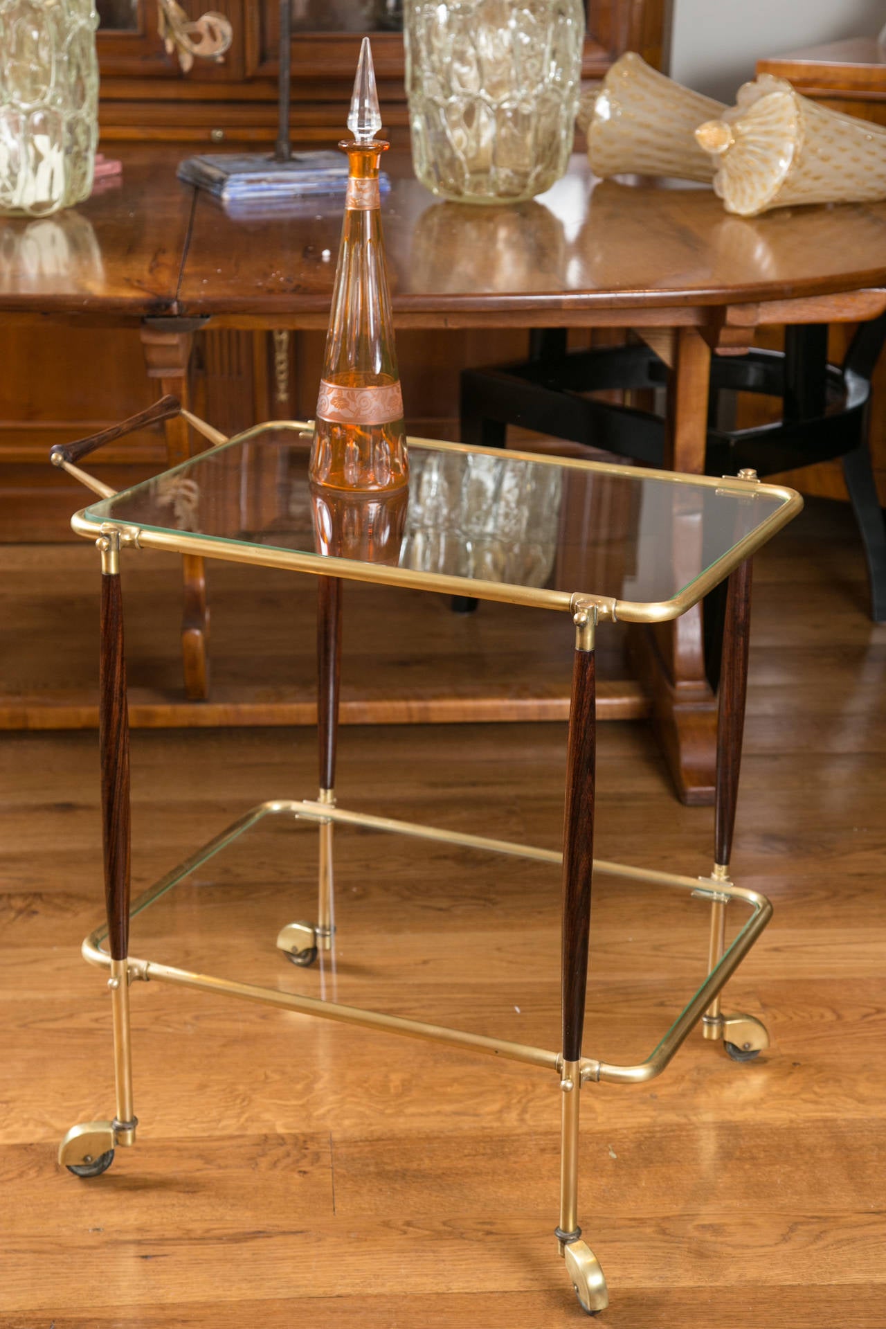 Wonderful Italian early 1950s bar cart in brass and rosewood with glass shelving.