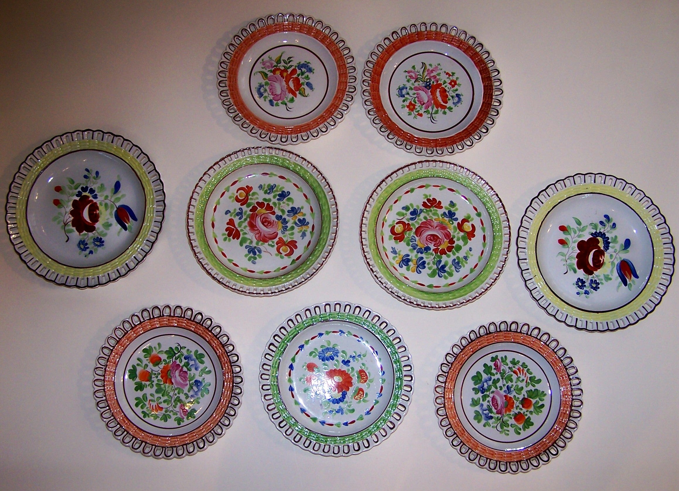 A Group of 9 Arcaded Creamware Plates in Bright Colors