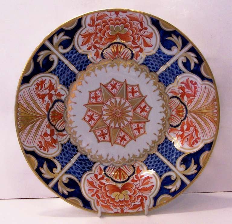 An early 19th century Derby plate with a bold geometric design, rich Imari colors, and beautiful gilding. 
Provenance: The Joseph Verner Reed Collection