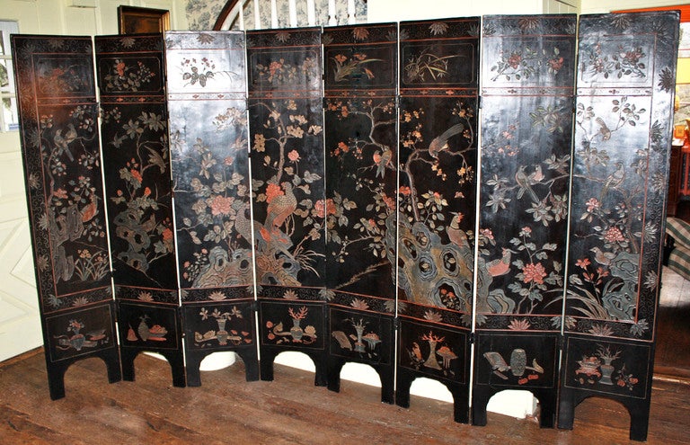 Of the Qing Dynasty Daoguang period (1820-1850), a Coromandel EIGHT PANEL TWO-SIDED incised lacquered screen.  The primary side is decorated with a palace landscape; including multiple human figures, pagodas, and a balustraded pond.  The top border