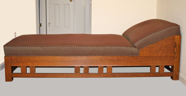 A specimen American Arts and Crafts - Mission Style chaise or daybed.  The tiger oak is strikingly grained and assembled.  The vertical slats connecting the aprons and stretchers are design elements employed by McHugh of New York, Limbert, as well