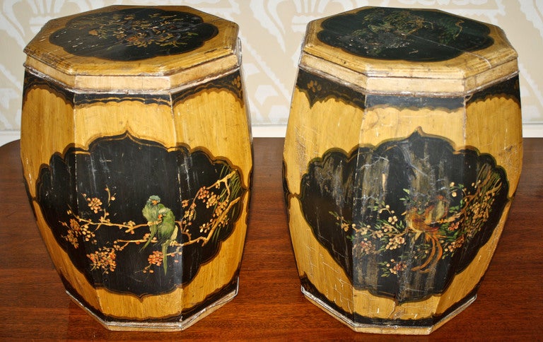 A pair of octagonal joined wooden barrels with bulging staves, incised and reinforced by fine twisted metal hoops near the top and bottom of each.  The painted fish and fowl panels on the sides and removable tops, are provincial and resemble ceramic