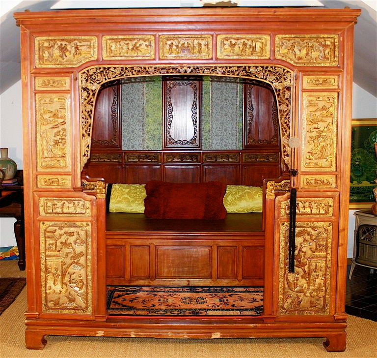 A Qing Dynasty monumental intricately carved chamber bed;  also referred to as a wedding bed, Lo-han, or 