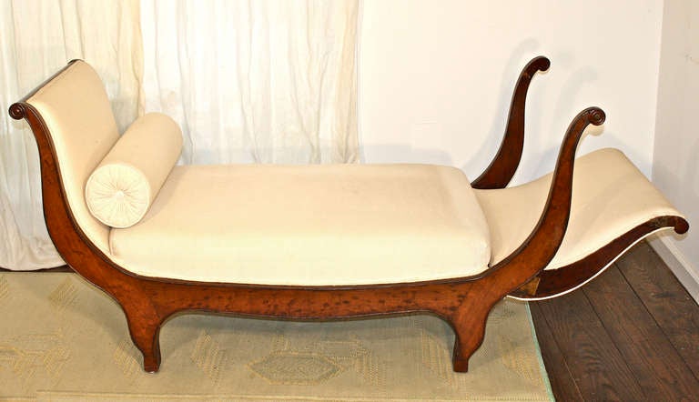 A late Charles X transitional to Louis Philippe period plum pudding mahogany framed provincial, metamorphic lit de repos;  folding down at one end to become a recamier.  As shown in Image 3, the length increases to 74.5