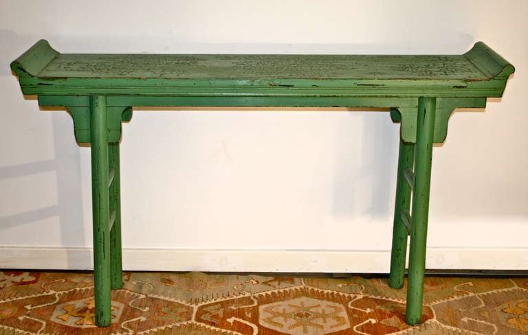 A northern provincial altar table with unadorned cylindrical legs joined by dual stretchers at each end;  in a most unusual jade green colored lacquer.  The Guangxu Emperor reigned from 1875 to 1908; wherein this table was made.  The proportions and