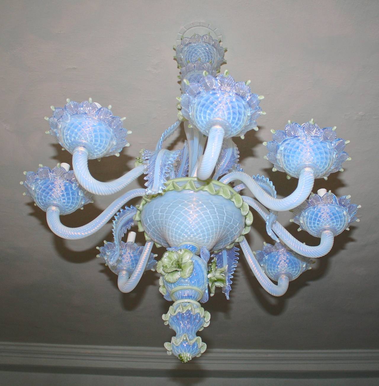 An eight-light Venetian Murano floral bouquet (ciocca) glass chandelier.  The palest blue and white handblown fronds, arms, bobeches and stacked urn baluster; mounted with pale green rose blossoms. Exceptionally detailed contrasting leaf tips, dew