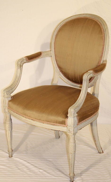 A refined hand planed, carved and turned, foliate decorated George III fauteuil in old paint.
