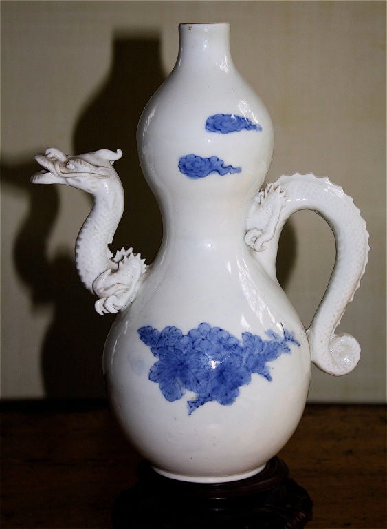 Rare double gourd ewer with a very fine and intricate dragon spout and tail<br />
handle.  Produced at Mikawachi near Arita, Japan.  Very pure highest quality<br />
porcelain.  Pieces made before 1843 were unmarked.