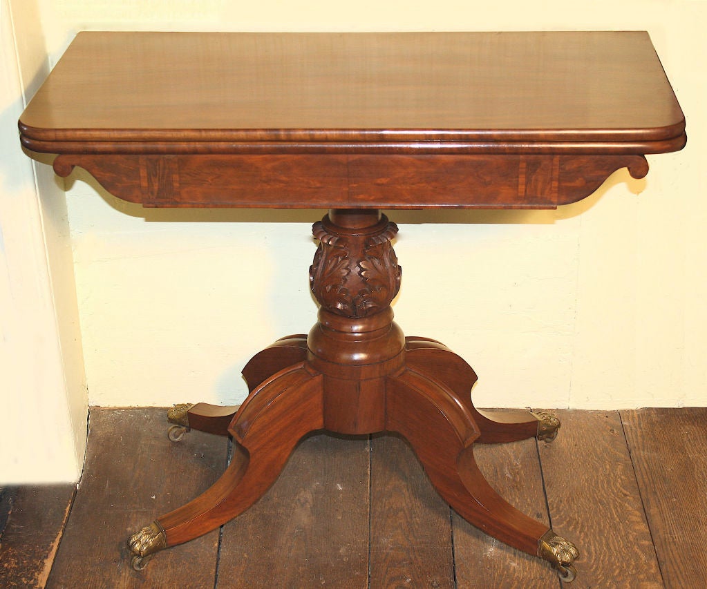 Attributed to the shop of Isaac Vose, a transitional (Federal to Classical period) baluster pedestal light mahogany card table; predating the plain rectangular pedestal form, for which the maker is more widely recognised.  The foliate carved