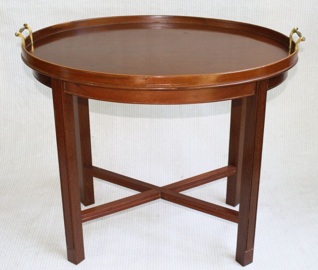 A 'fishtail' handled mahogany tray with scalloped gallery AND a brass handled mahogany tray with plain gallery; both attached on four-legged cross-stretchered matching mahogany stands, with 'routed' trim.  A utilitarian pair.  Could be 'low'