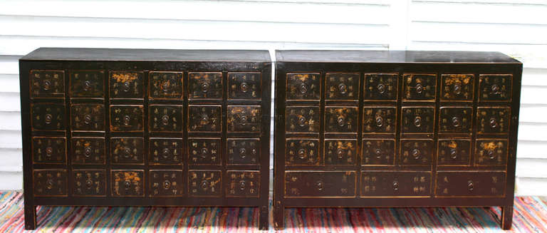 From the southeastern Province of Jiangxi and likely made during the last decade of the 19th century (or closing years of the Qing Dynasty);  two lacquered apothecary chests of virtually identical case measurement.  The drawer configurations differ