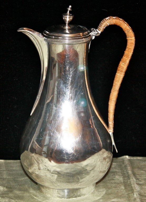 A Georgian sterling silver 'footed pear' coffee pot with hinged cover, and cane wrapped handle. 18 Troy ounces. Markings indicate London, 1789.