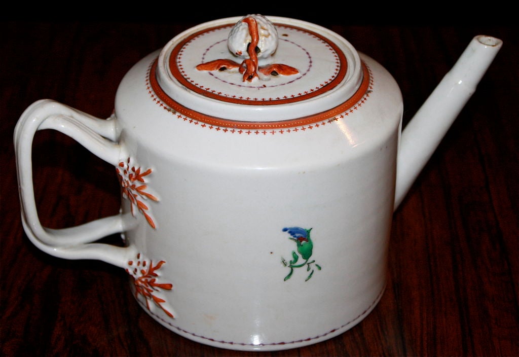 Rare and eccentric Chinese export porcelain teapot with a white 'hybrid' strawberry or raspberry finial. Red sprig decoration and bands, twisted vine handle, and bamboo spout; small blue flower buds on each side. Likely made for the European