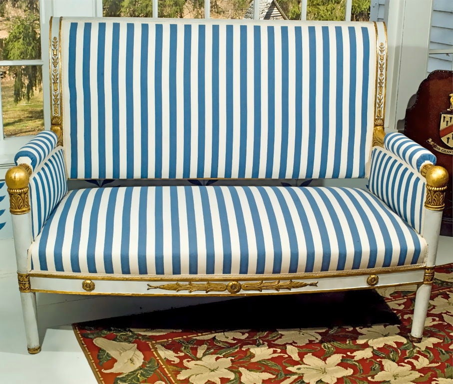 A Russian Empire Alexandrine (French Empire influenced) upholstered settee in its original paint;  with gilded acanthus carved and foliate relief surfaces, rosettes, and arm spheres.  Significant historical reference:  the United States White House