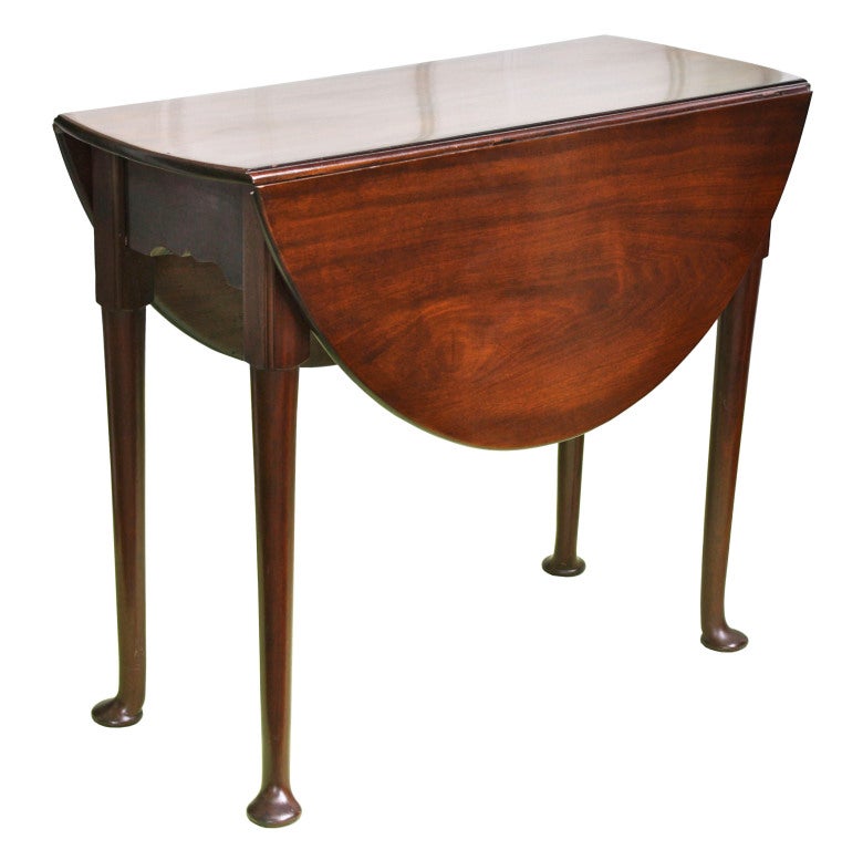 Of select, grain-matched Santo Domingo mahogany; a slightly diminutive Queen Anne drop-leaf table.  The leaves raise to form a 33.5