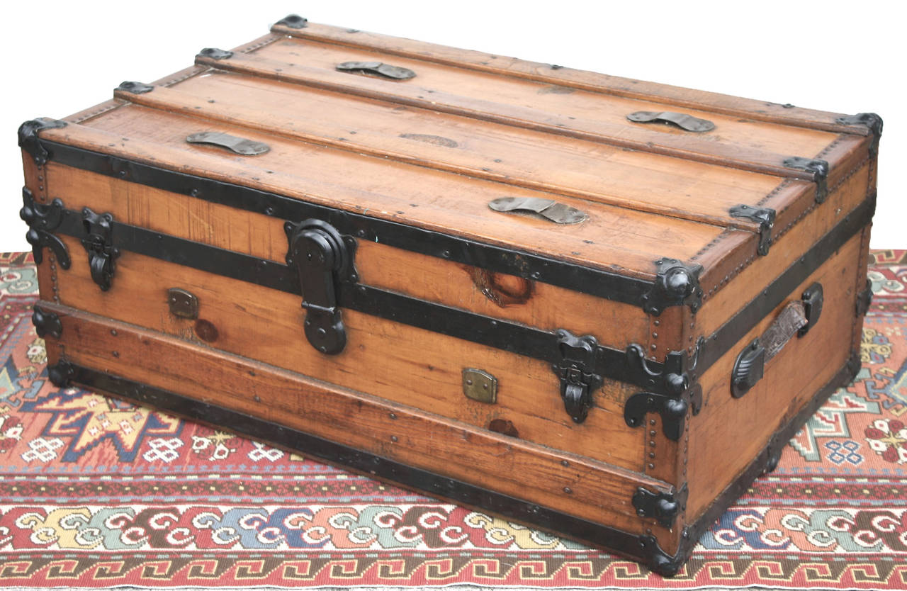 An unusual American pine 'cabin' or 'carriage' trunk from the mid-late 19th century. Unfinished underneath, as it was not made to be used standing up, it likely rode at the rear of a carriage; and was useful beneath a berth on a steamer or train. It