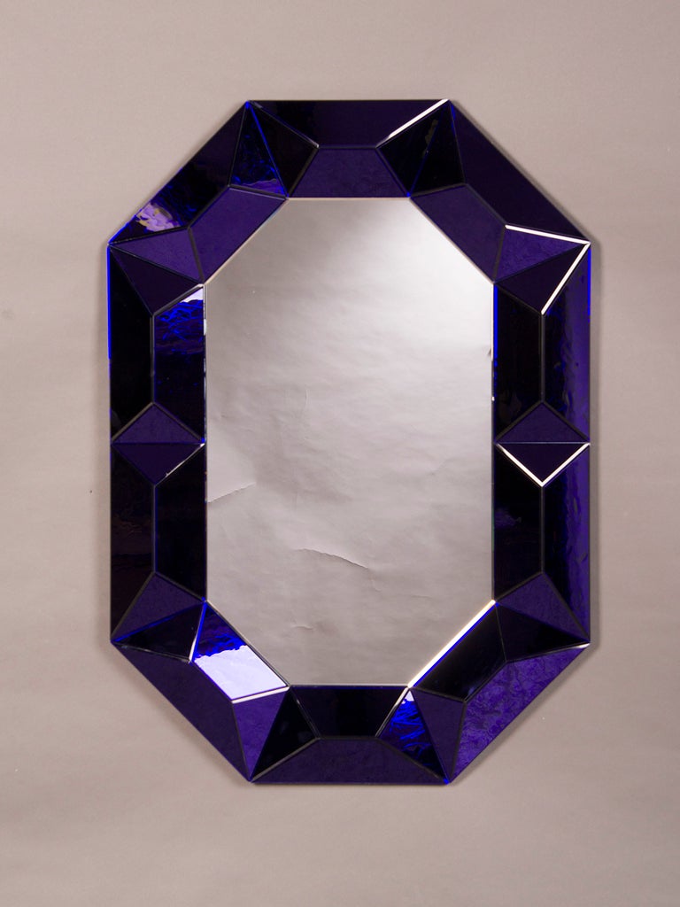 A striking cobalt blue Lucite octagonal frame enclosing the original mirror glass from Italy c.1970. This extraordinary frame is composed of forty individually placed panels of coloured Lucite each with an organic pattern on the reverse side. Please