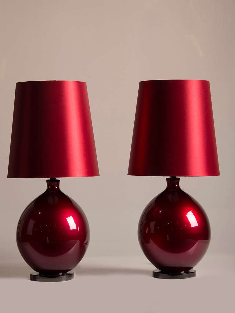 Pair Burmese Ruby Glass Vessels, Italy c.1940, Mounted as Lamps. These vintage lamps possess a mesmerizing quality because of the unique colour and elegant profile of the glass. The deeply vibrant colour is reminiscent of the finest rubies found in