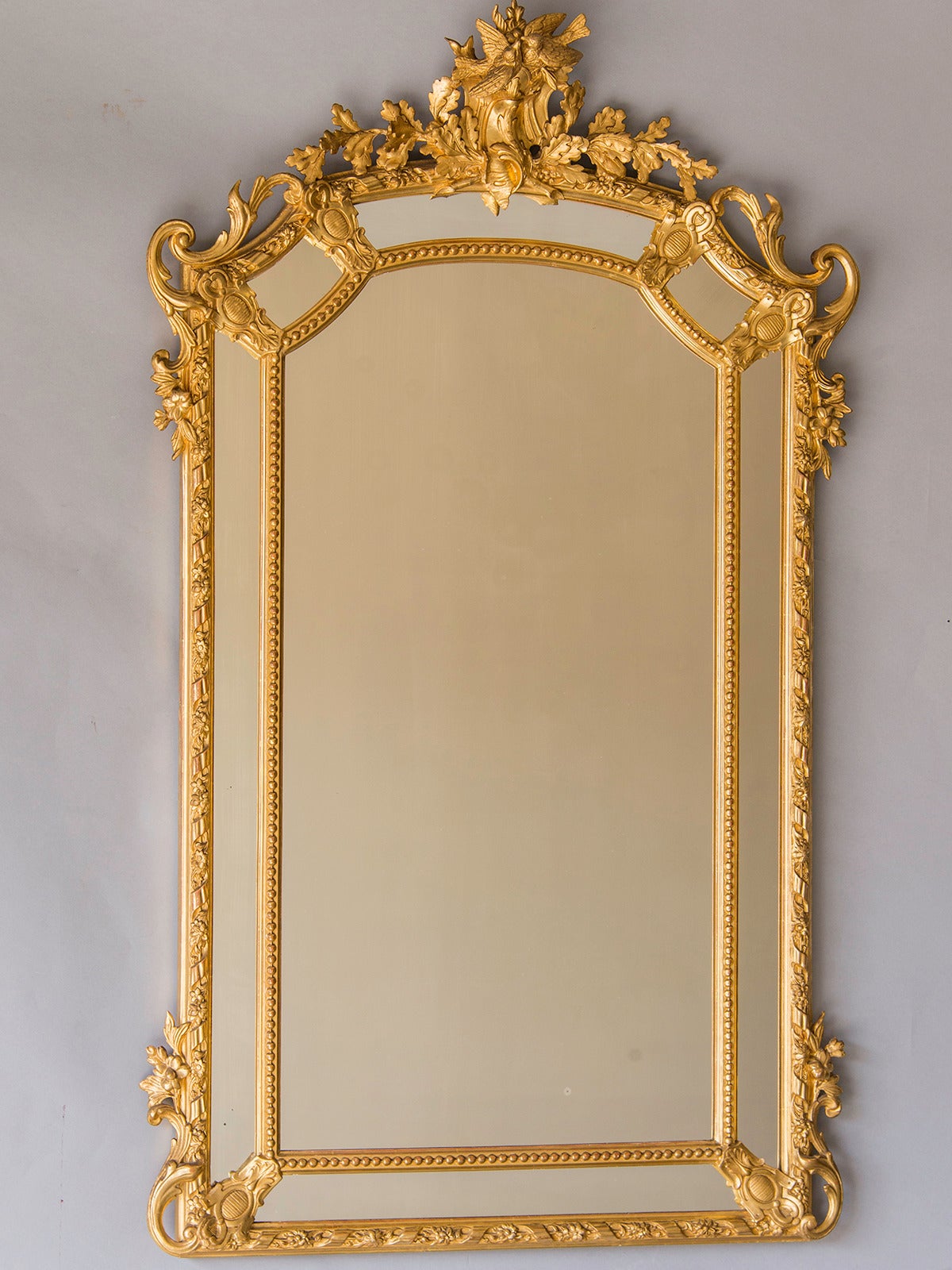 Régence Style Gold Leaf Pareclose Mirror, France c.1890. This mirror has an architectural impression because of its origin from the Régence period in France between the reign of Louis XIV and Louis XV (1715-1723) when the design of furnishings